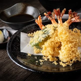 The tempura shrimps with sauce, deep-fried shrimps in the traditional Japanese restaurant.